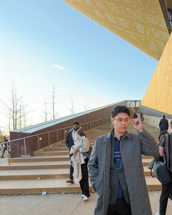 Braxton Mondell walking past a gold building