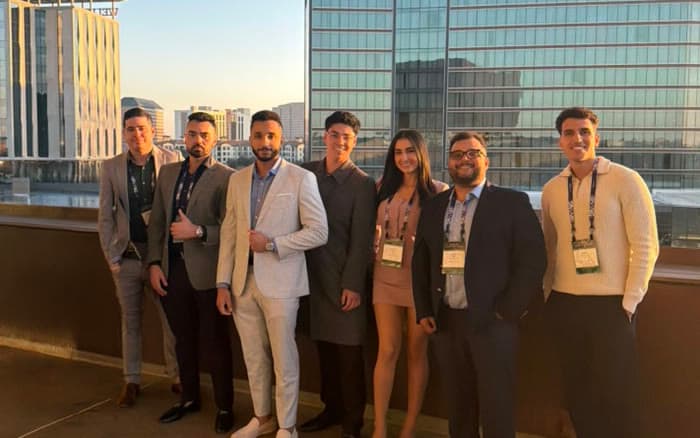 Joelle Noun with the Checkmate team on a rooftop terrace at an industry conference