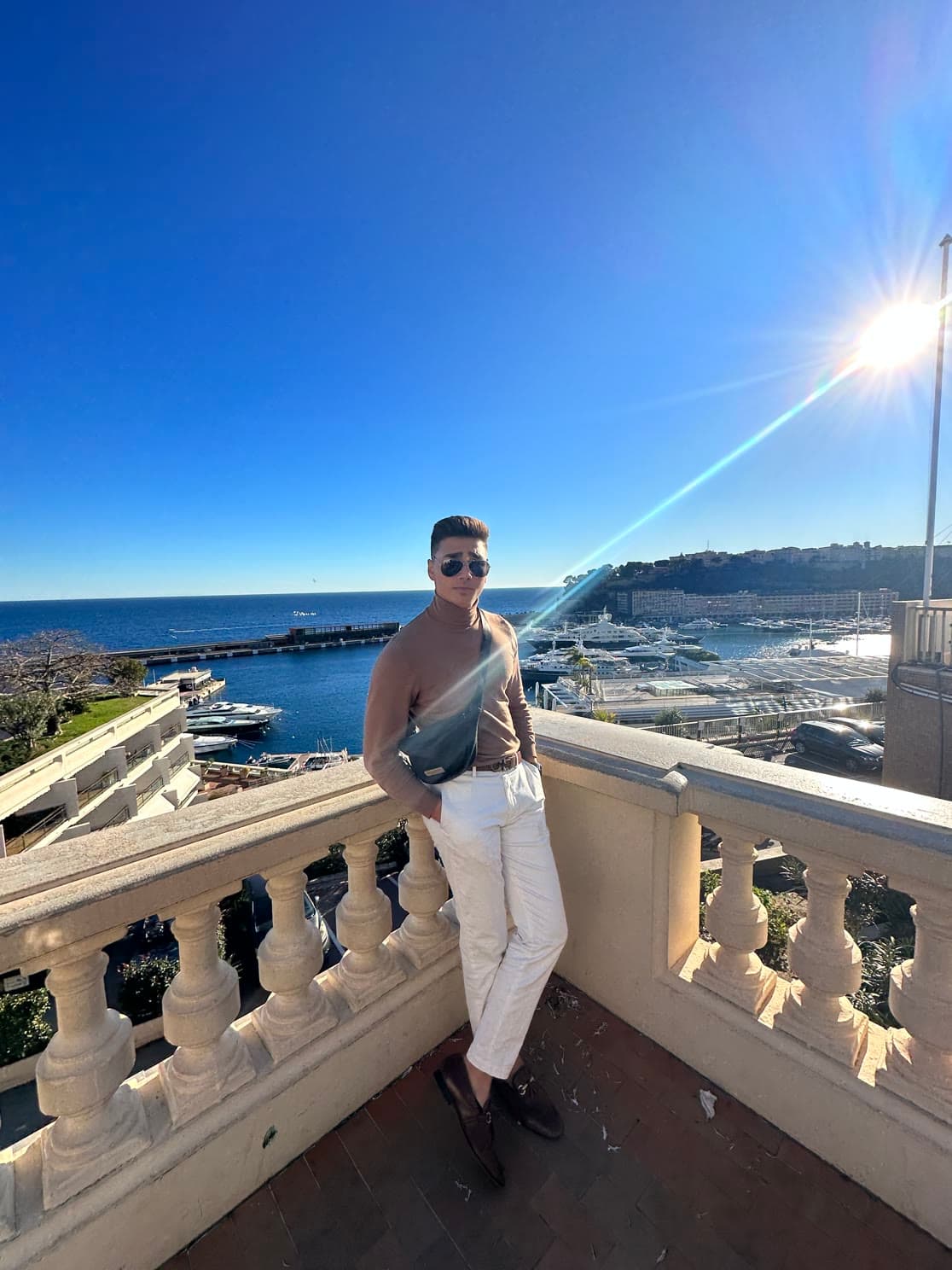 Zaid Alsalhani on a seaside terrace overlooking a marina